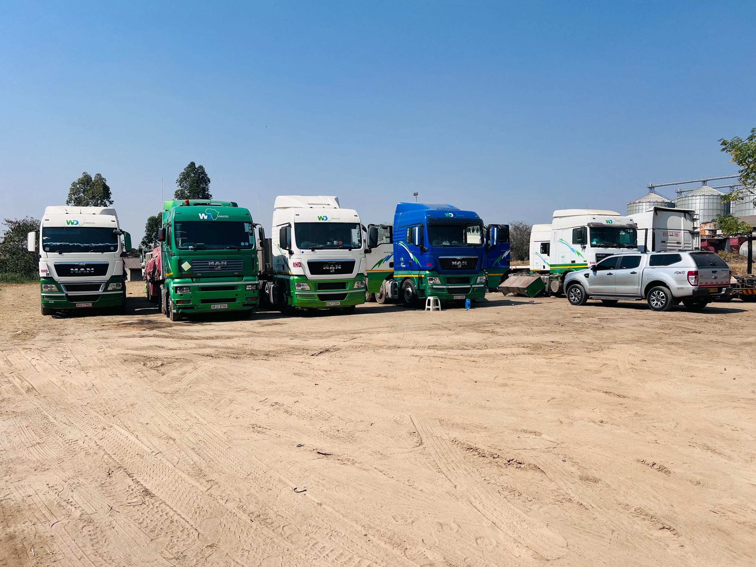 Five WD Logistics trucks lined up in the company yard in Mutare, Zimbabwe
